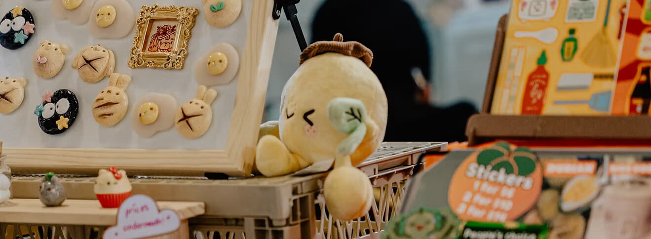 Plush toys and clay charms at a market stall